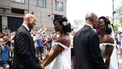 അമേരിക്കയില്‍ വംശീയതയ്‌ക്കെതിരെ നടക്കുന്ന പ്രതിഷേധത്തിന് നടുവില്‍ ഒരു വിവാഹം; വൈറലായി വീഡിയോ