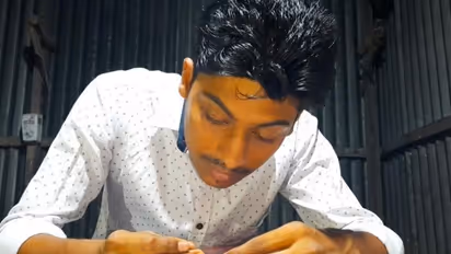 Teenage boy finds place in India Book of Records for painting smallest national flag on poppy seeds