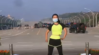 Fitness trainer who missed a coup unfolding behind her is a global sensation