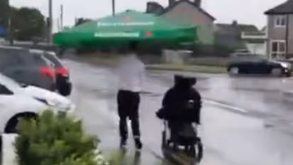 Cafe worker helps patron who uses a wheelchair in heavy rain; Watch Viral Video
