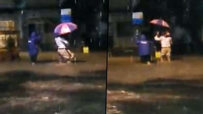 Watch how Mumbai police help father-daughter during heavy rains (Video)