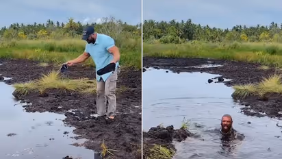 Watch: Man gets submerged in muddy water while crossing a swamp; watch viral video