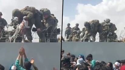 Afghan conflict: Infant handed to US troops over Kabul airport wired fence treated, reunited with family