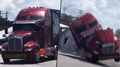 Train crashes into 18-wheeler carrying wind turbine blade; watch video