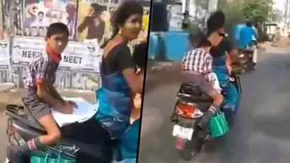 Watch: Student completes homework on scooter's backseat on his way to school; viral video