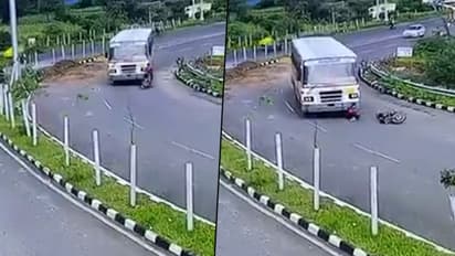 Biker miraculously escapes unhurt after getting run over by bus; watch video