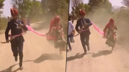 Here’s why a newly-wed couple was running on the road in their wedding attire; watch