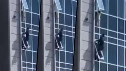 WATCH: Man climbs to the window of 8th floor to save a child