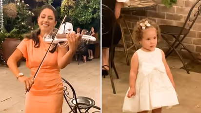 Watch: Little Girl's adorable response to woman playing violin is winning hearts