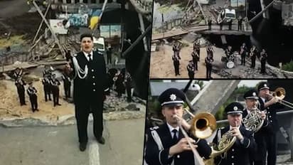 An ode to courage: Ukrainian cops sing national anthem over bridge Russians bombed