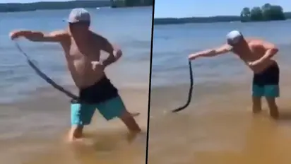 Man catches snake and wrongly tosses on other people swimming in lake; find out what happens next