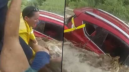Cops save woman trapped in car amid rising flood waters: watch video