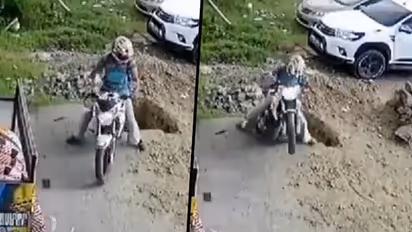 Man falls into pit while reversing a bike; video goes viral