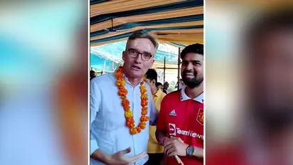 Seeking divine intervention... UK envoy roasts Manchester United supporter at temple in Delhi