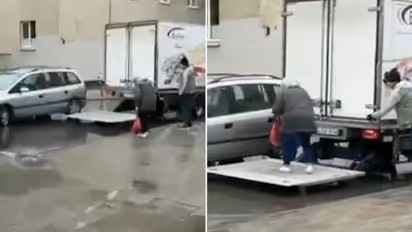 Watch: Truck driver helping elderly woman cross waterlogged street wins internet hearts
