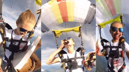 സ്കൈ ഡൈവിങ്ങിനിടെ ഭക്ഷണം കഴിക്കുന്ന യുവതി; രസകരം ഈ വീഡിയോ