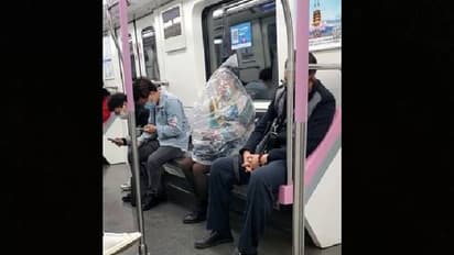 പഴം കഴിക്കണം, കൊവിഡ് നിയന്ത്രണമാണ്, ശരീരം പ്ലാസ്റ്റിക് കവറിൽ മൂടി സ്ത്രീ