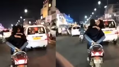 నడిరోడ్డుపై స్కూటీ పై వెళుతూ రొమాన్స్... వీడియో వైరల్..!