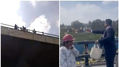 തിരക്കുള്ള നഗരം, മേല്പ്പാലത്തിൽ നിന്ന് നോട്ടുകള് വാരിയെറിഞ്ഞ് യുവാവ്; പെറുക്കി കൂട്ടാൻ വൻ ജനക്കൂട്ടം!