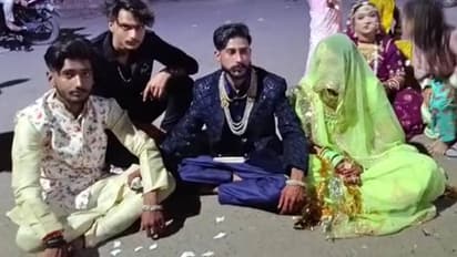 bride and groom sitting on dharna