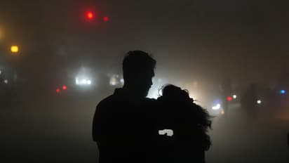 A couple on a road during thunderstorm in Kolkata