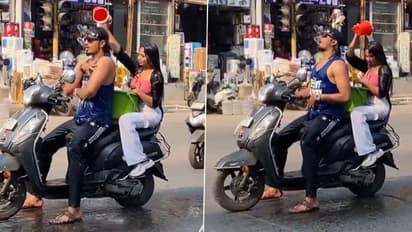 സ്കൂട്ടറിൽ കുളിക്കാനിറങ്ങിയ പുരുഷനും സ്ത്രീയും; വൈറലായി വീഡിയോ