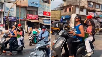 ಸ್ಕೂಟಿಯಲ್ಲಿ ಸಾಗುತ್ತ ನಡುರಸ್ತೆಯಲ್ಲಿ ಸ್ನಾನ: ಮಜಾ ನೋಡಿದ ವಾಹನ ಸವಾರರು