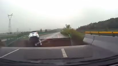 WATCH: Terrifying video shows car plunging into massive crater in China as Typhoon Doksuri destroys roads