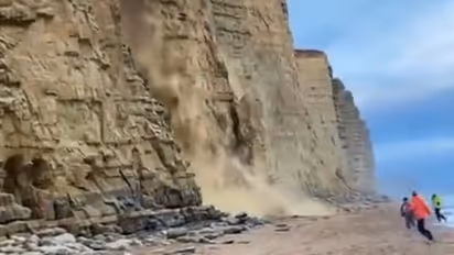 WATCH narrow escape: Tourists dodge collapsing cliff in dramatic Dorset incident