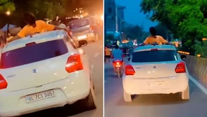 Noida man performs stunt on car roof, owner fined Rs 26,000 | WATCH