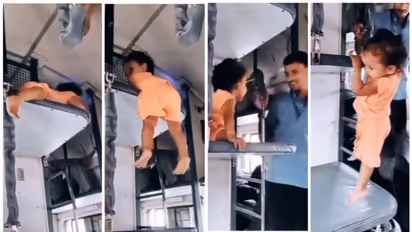 ഇതൊക്കെയെന്ത്?; മുകളിലെ ബര്‍ത്തില്‍ നിന്ന് ഏറ്റവും താഴത്തെ ബര്‍ത്തിലേക്ക് ഊര്‍ന്നിറങ്ങുന്ന കുഞ്ഞിന്‍റെ വീഡിയോ