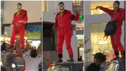 ഇതാര്, 'മണി ഹെയ്സ്റ്റിലെ പ്രഫസറോ', ഓൾട്ടോ കാറിന് മുകളിൽ കയറി നിന്ന് നോട്ടുകൾ വാരിയെറിഞ്ഞു, കാരണം?