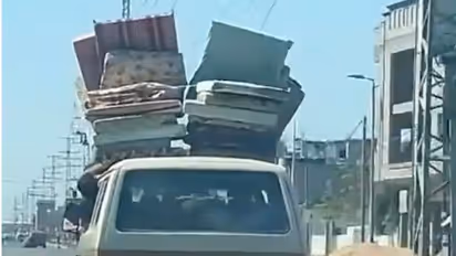 Gaza residents flee with mattresses strapped to cars after Israel's evacuation ultimatum (WATCH)