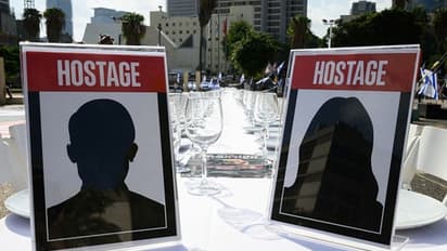 Over 200 empty chairs: Israelis set up symbolic Shabbat Dinner tables for hostages held by Hamas (WATCH)
