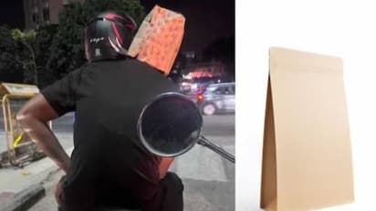 ഹെൽമറ്റിന് പകരം യുവാവിന്റെ തലയിൽ പേപ്പർ ബാ​ഗ്, വൈറലായി ചിത്രം