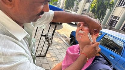 Michael Vaughan, former England cricket captain, gets a haircut and shave at Mumbai's roadside barber (WATCH)