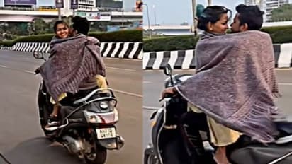 కదిలే స్కూటీపై జంట రొమాన్స్.. హగ్గులు, కిస్సులతో రోడ్డుపైనే రెచ్చిపోయిన ప్రేమికులు.. వైరల్..