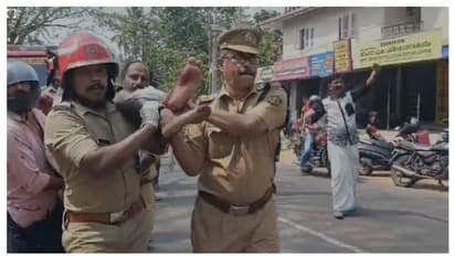 റോഡരികിൽ കൂട്ടിയിട്ട വൈദ്യുതി പോസ്റ്റുകൾക്ക് മുകളിൽ കിടന്നു, ഞെരിഞ്ഞമർന്നു, യുവാവിന് രക്ഷയായി ഫയർഫോഴ്സ്