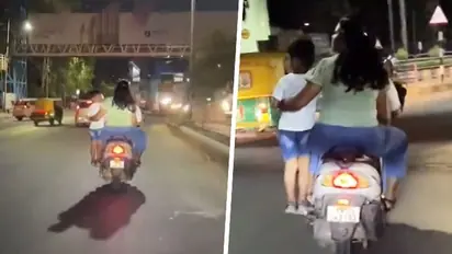 SHOCKING! Bengaluru couple rides scooter with child standing on footrest, netizens furious (WATCH)