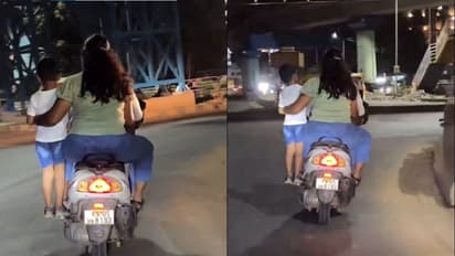 Bengaluru couple rides scooter with child standing on footrest, Internet puzzled; WATCH viral video 