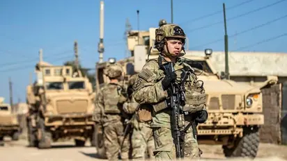 Iraq's Kataib Hezbollah denies saying it was resuming attacks on US forces as base in Syria is targeted