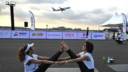 Yogis take flight! Hundreds of people perform yoga on runway of Bangkok's main airport (WATCH)