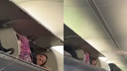 Viral video: American woman climbs into luggage compartment of plane to take a nap [watch]