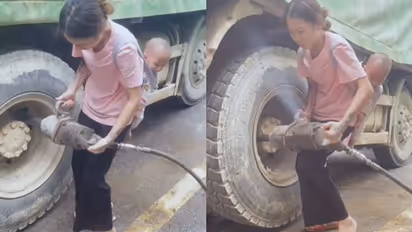 Video of mother fixing truck tire with child on her back goes viral