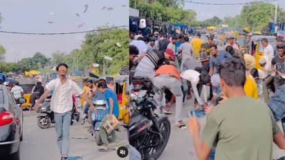 തിരക്കേറിയ റോഡ്, നോട്ടുകൾ വാരിയെറിഞ്ഞ് യുവാവ്, വിമർശനവും പ്രോത്സാഹനവുമായി നെറ്റിസൺസ് 