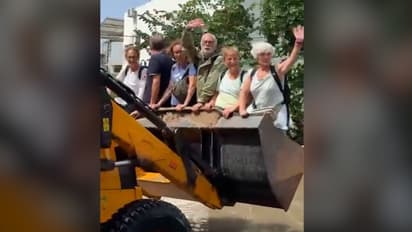 Gujarat floods: Foreign tourists enjoy ride on bulldozer amid Vadodara deluge; video goes viral (WATCH)