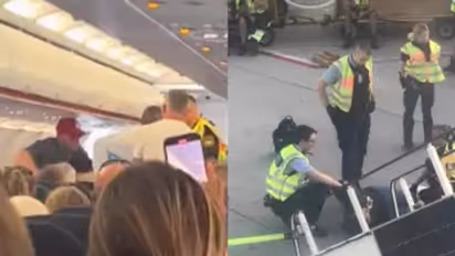 Mid-air horror as drunk EasyJet flyer storms cockpit, then tries to open exit door at 30,000 ft (WATCH)