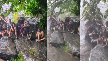 വെള്ളച്ചാട്ടം കണ്ടു നിൽക്കെ മലവെള്ളപാച്ചിൽ; വിനോദ സഞ്ചാരികള് പാറക്കെട്ടിൽ കുടുങ്ങി, രക്ഷകരായി അഗ്നിശമന സേന