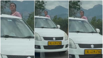 കേരള രജിസ്ട്രേഷൻ ടാക്സി കാറിൻ്റെ ഡോറിലിരുന്ന് യുവതിയുടെ അപകട യാത്ര, വീഡിയോ പുറത്ത്! മൂന്നാറിൽ അന്വേഷണം