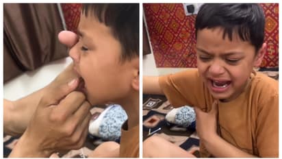 അച്ഛൻ തന്‍റെ പല്ല് പറിച്ചതിന് പിന്നാലെ നെഞ്ചത്തടിച്ച് 'ഞാൻ ശക്തനായ ആൺകുട്ടിയാണെന്ന് കരഞ്ഞ് പറയുന്ന മകൻ; വീഡിയോ